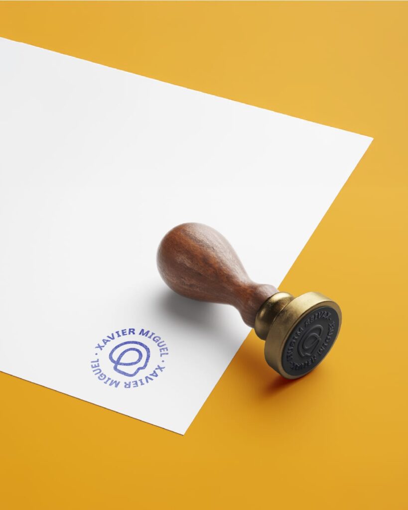 Circular stamped logo of Xavier Miguel alongside a stamping machine, designed by Vikini Studio